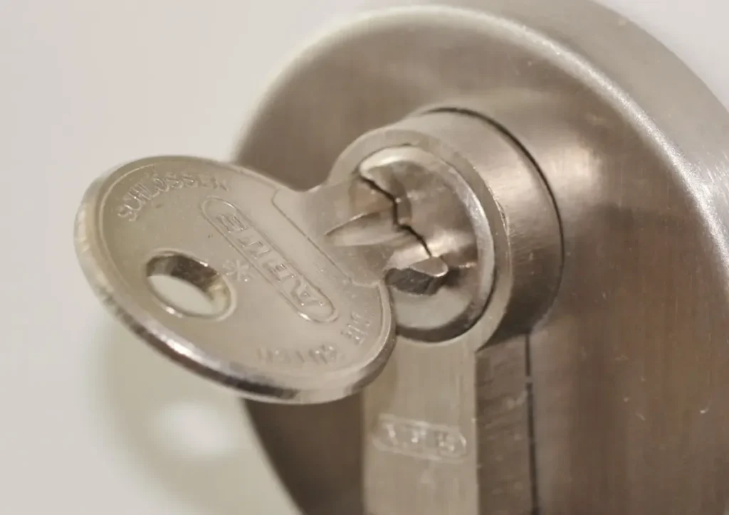 Key inserted in a door lock cylinder – how to choose a trustworthy locksmith in Normanton before a lock is drilled or replaced, Locksmith Normanton
