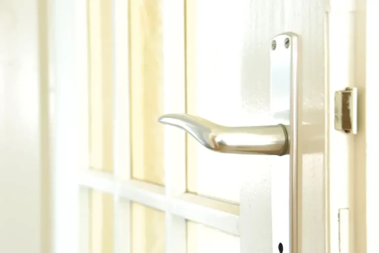 How to change a uPVC door lock in Normanton – white door with a lever handle on a long backplate, Locksmith Normanton guide to barrel, handle and multipoint replacement