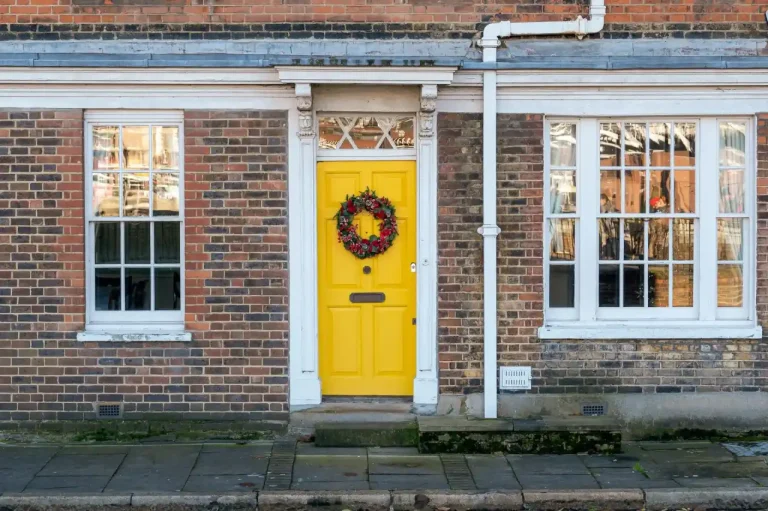 Types of door locks in the UK – yellow front door on a red-brick Victorian house in Normanton, Locksmith Normanton guide to identifying your lock